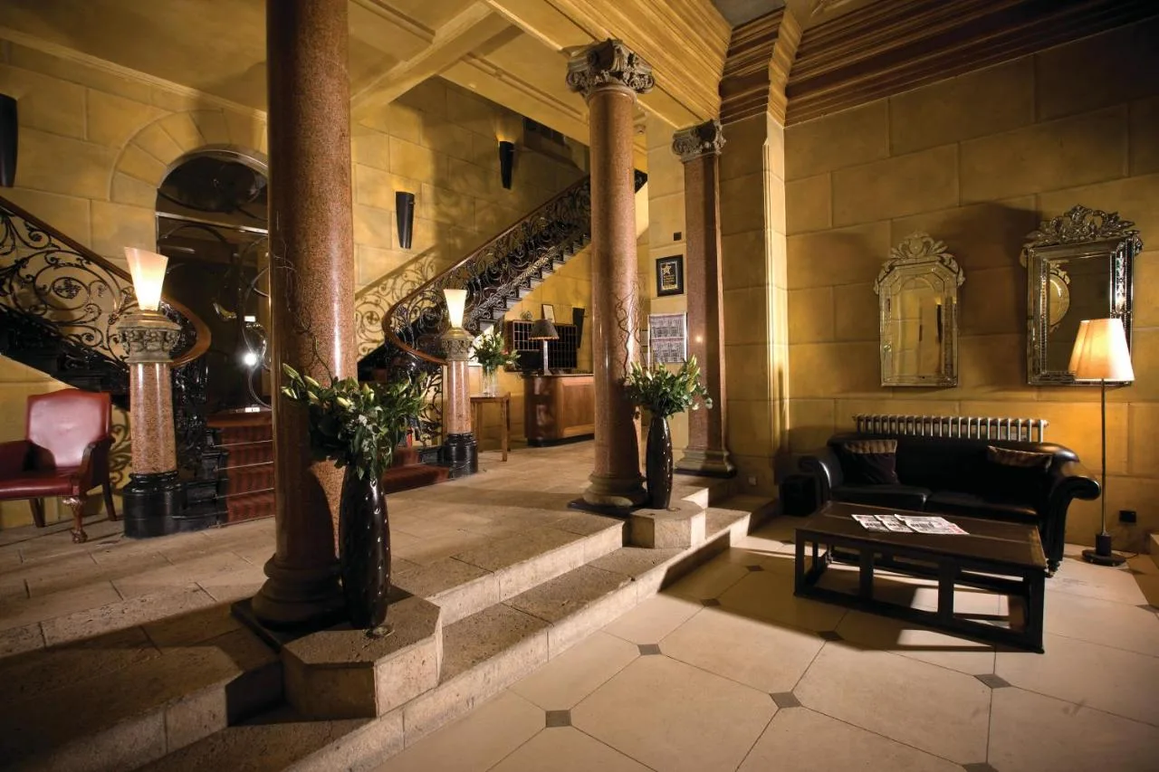 a lobby with a couch and a table in a building at Hotel du Vin Birmingham in Birmingham