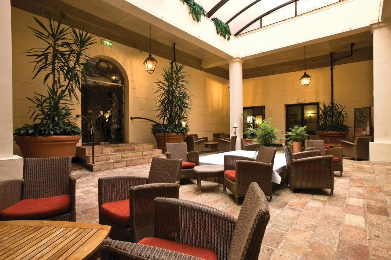 a restaurant with tables and chairs and plants at Hotel du Vin Birmingham in Birmingham