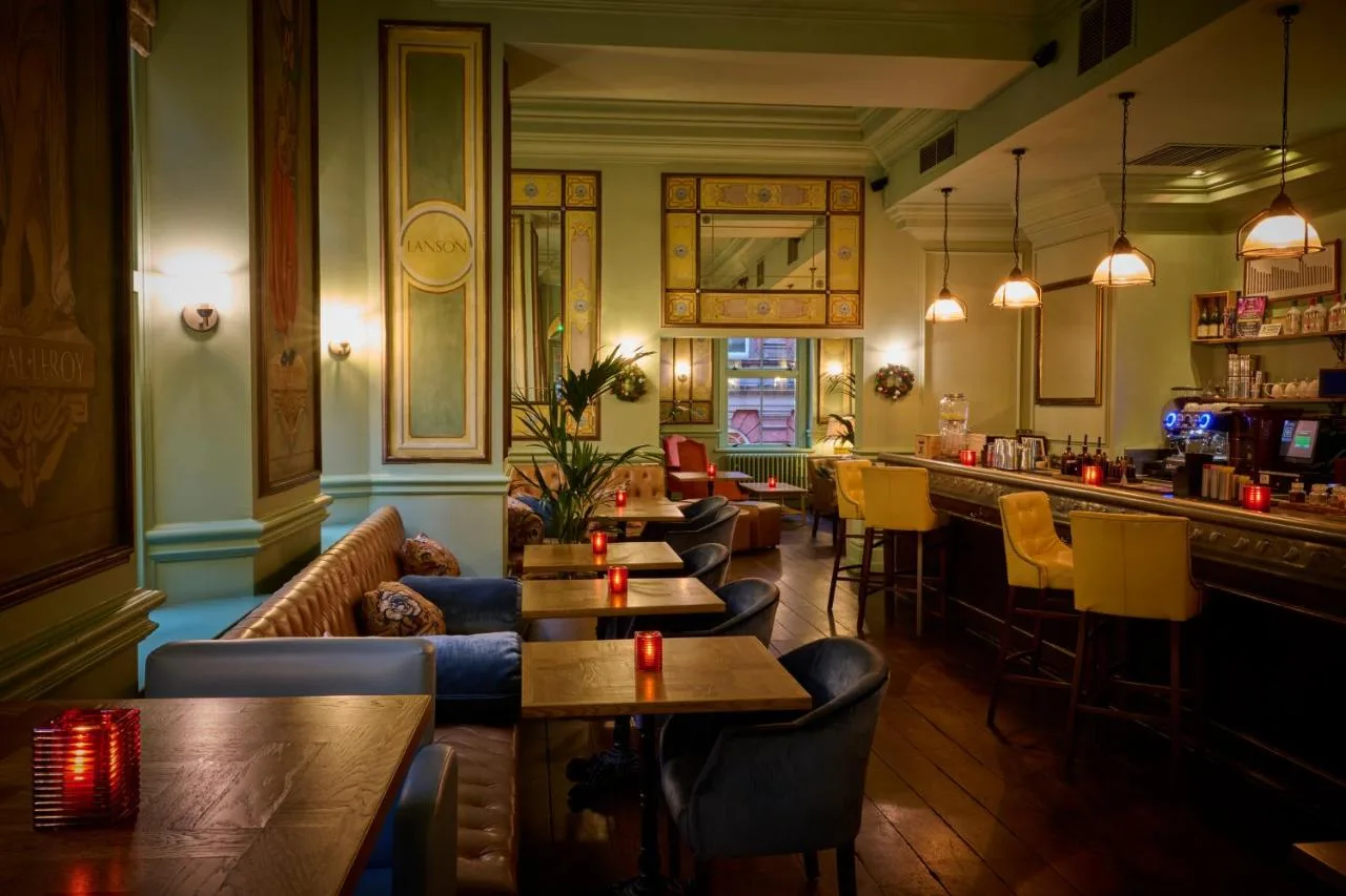 a restaurant with couches and tables and a bar at Hotel du Vin Birmingham in Birmingham
