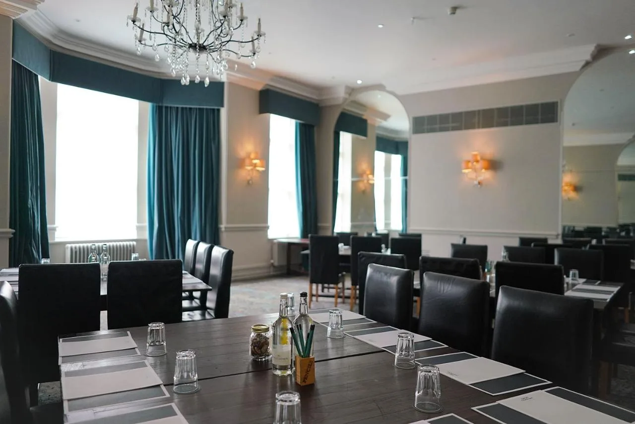 a conference room with a long table and chairs at Hotel du Vin Birmingham in Birmingham